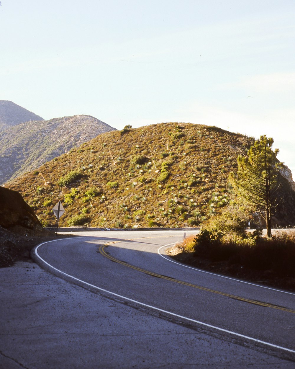 gray concrete road near hill