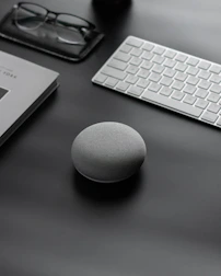 Minimalist workspace featuring elegant branding materials and a luxury speaker preparing notes.
