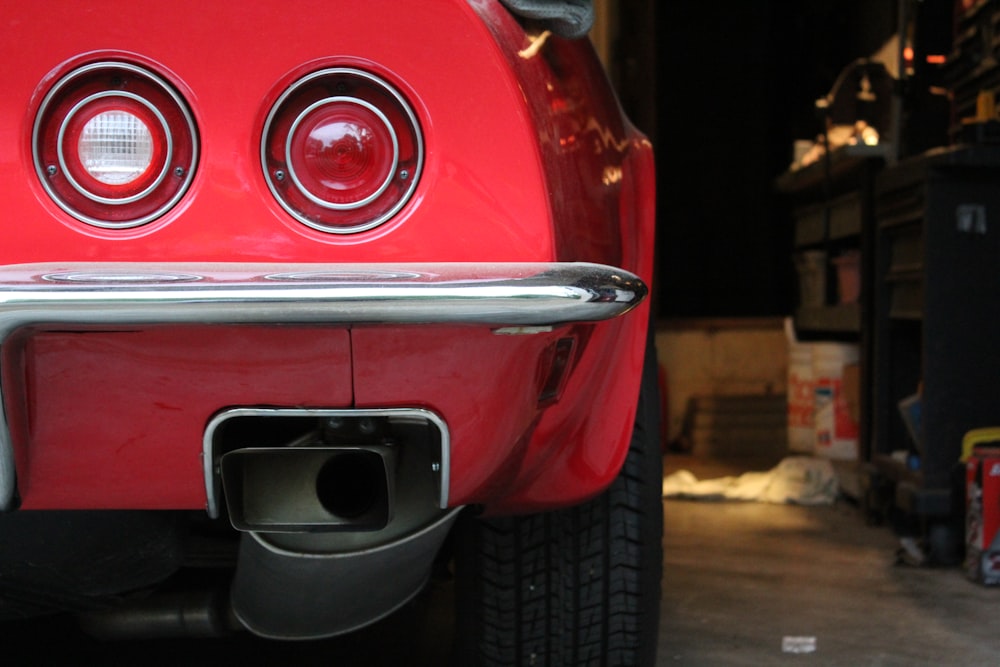 a close up of the front end of a red car