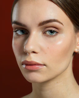 Close-up of a youthful woman with even skin tone and natural makeup