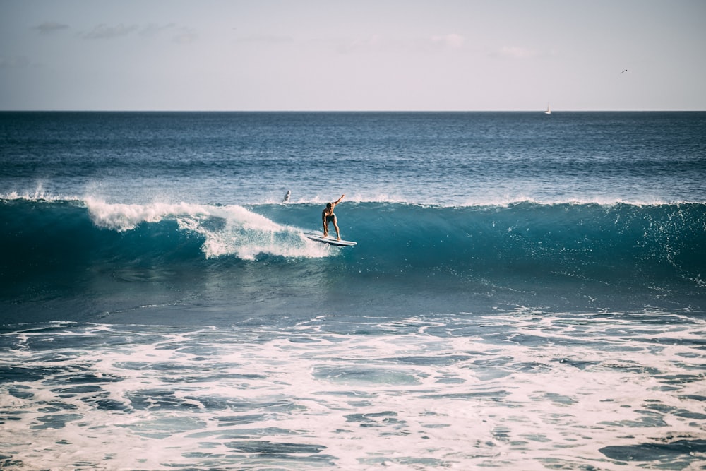 person riding on surfboard