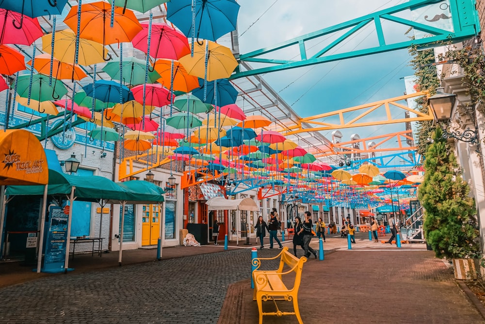 people walking under umbrellas