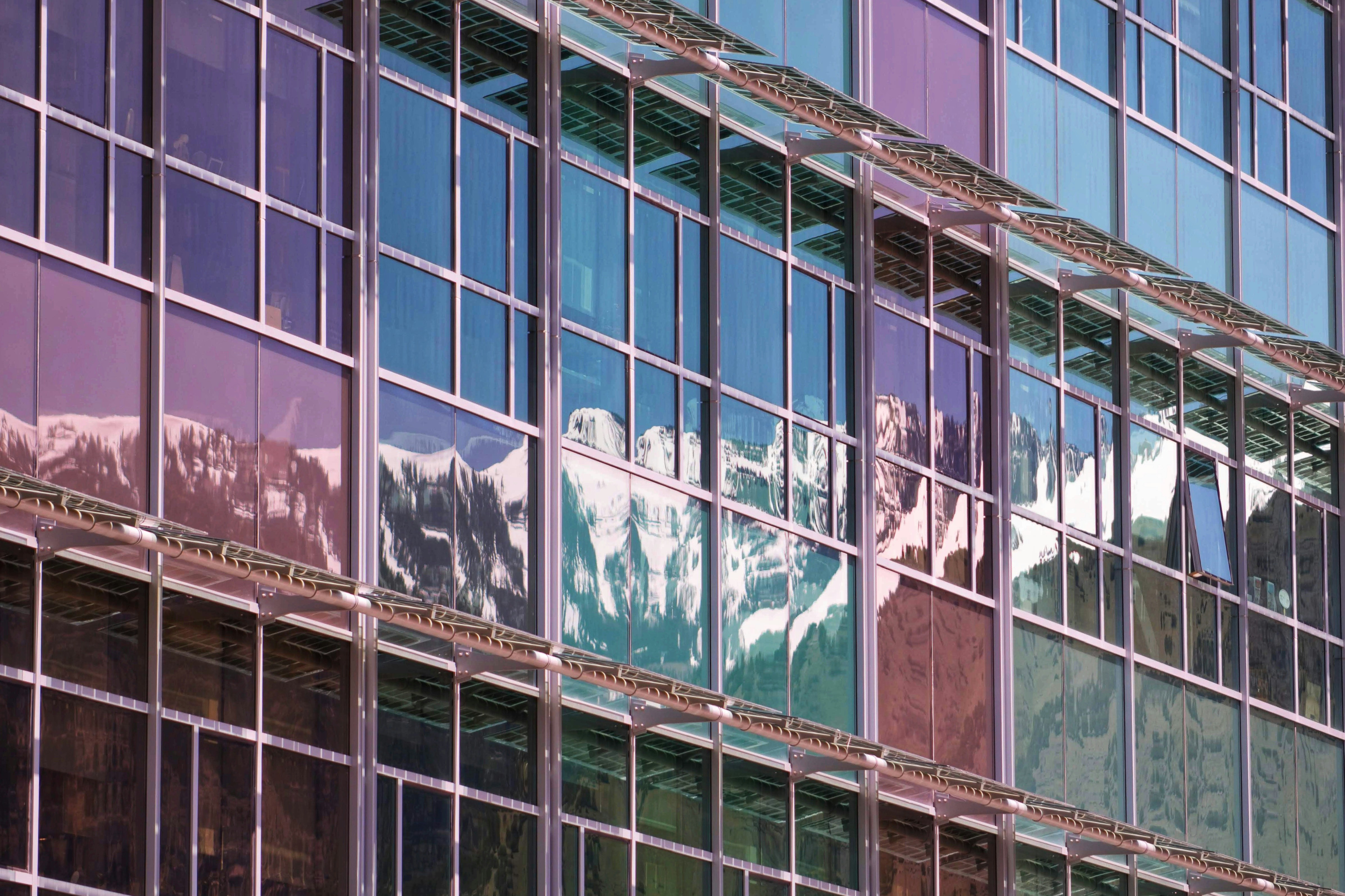 Glass building with mountain reflections