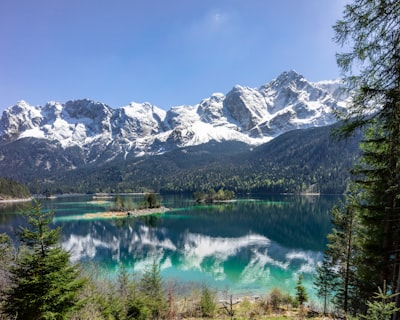 reflections of mountains on calm body of water germany teams background