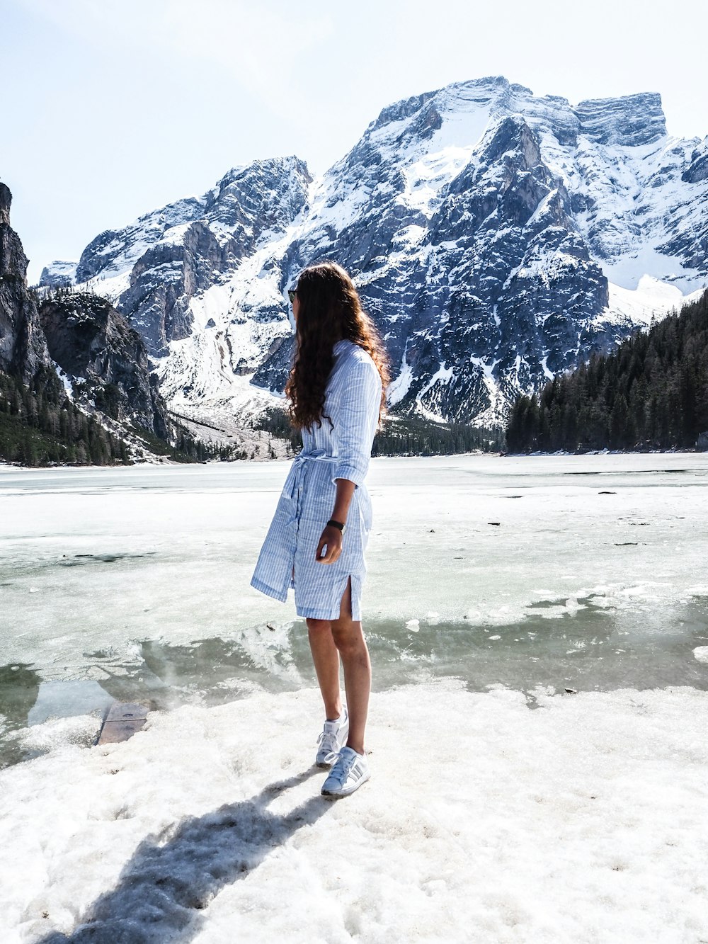 woman standing near snow covered field during daytime