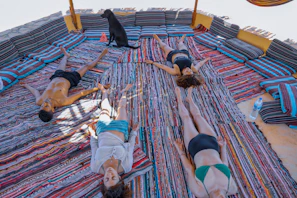 Group of people wrapped in cozy blankets, eyes closed, immersed in the soothing sound waves