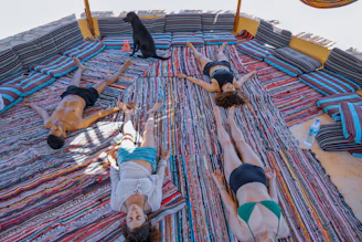 Group of people wrapped in cozy blankets, eyes closed, immersed in the soothing sound waves