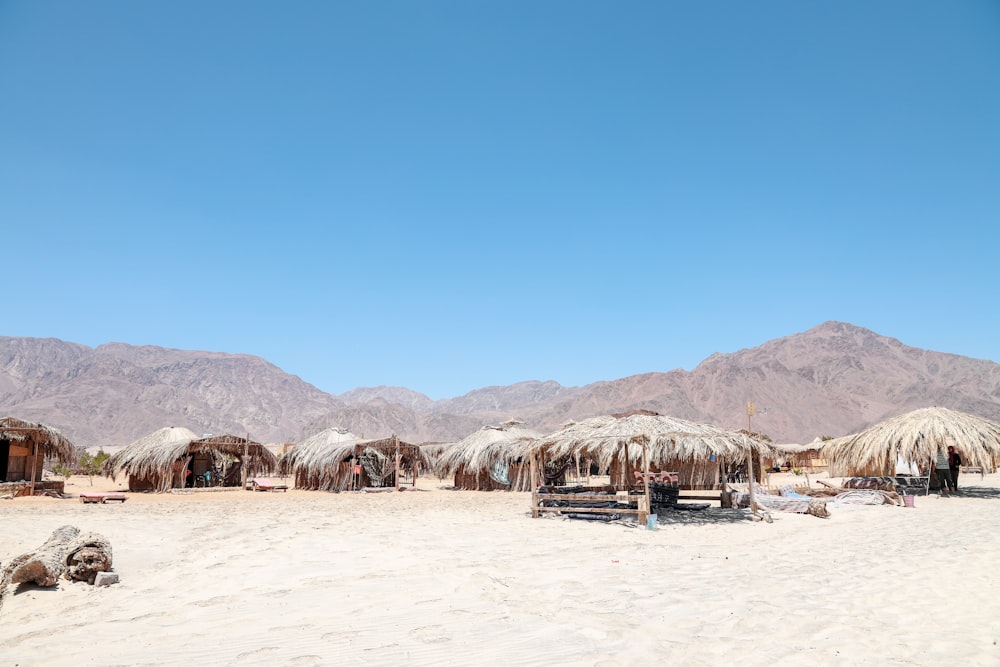 brown huts on desert during daytime