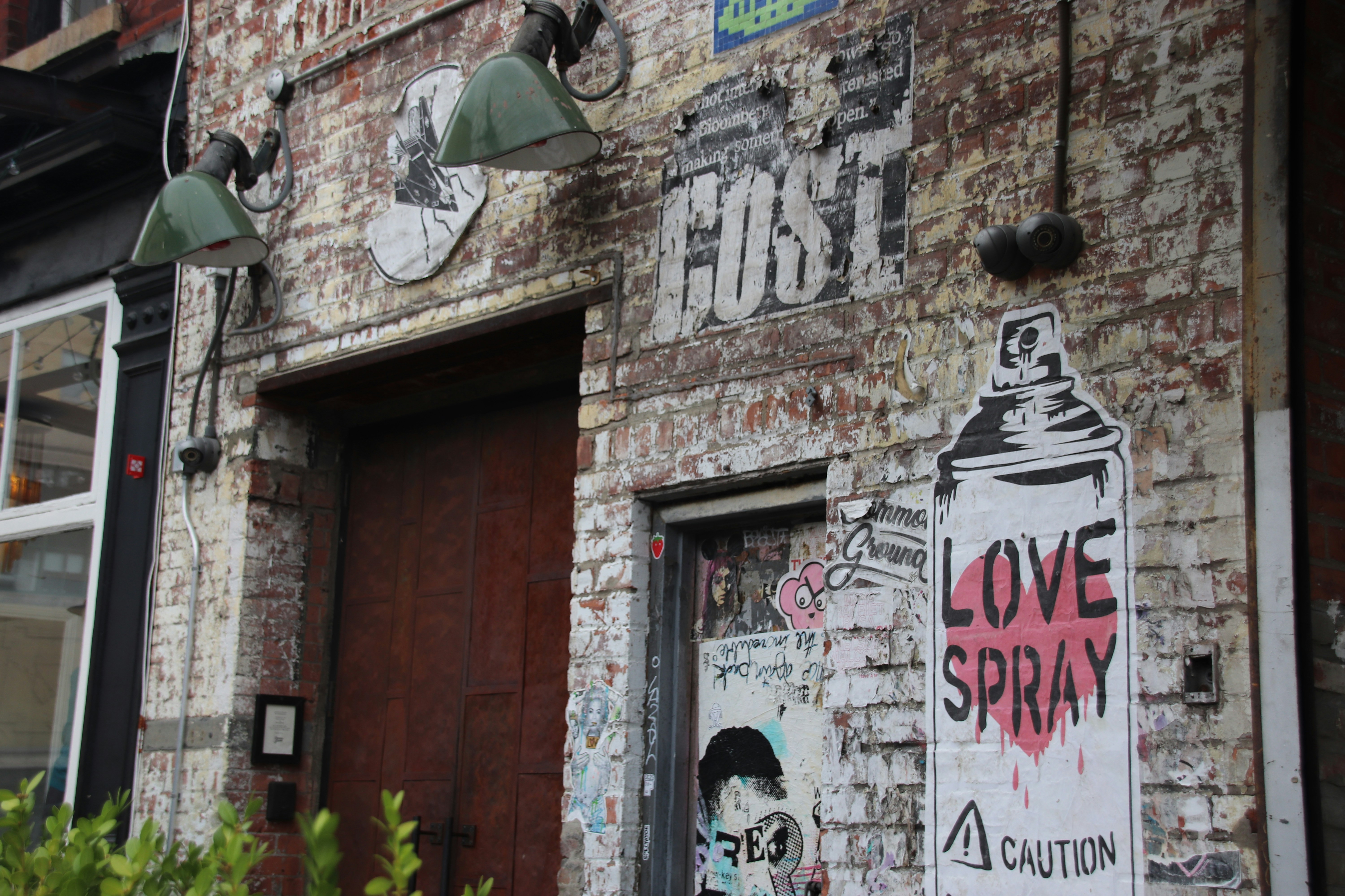 Masonry wall with spray paint graffiti before removal treatment