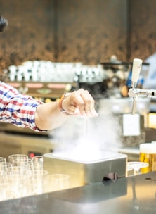 Technician using professional-grade equipment to remove smoke odor from a room.
