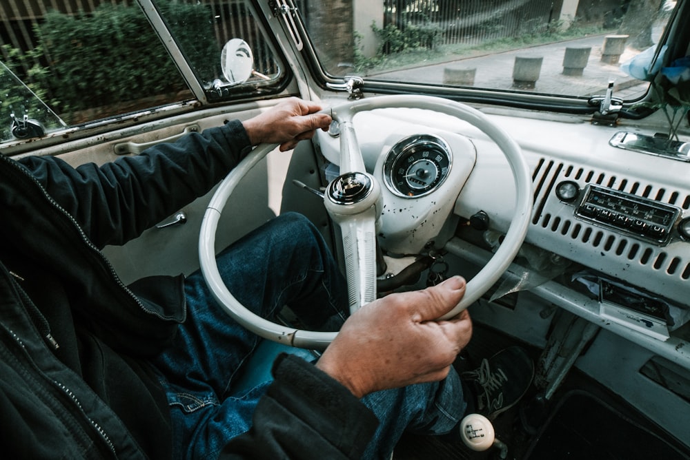 person holding steering wheel