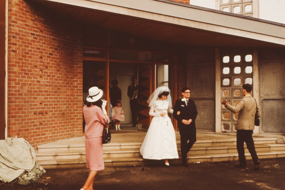 groom and bridge walking near outdoor during daytime