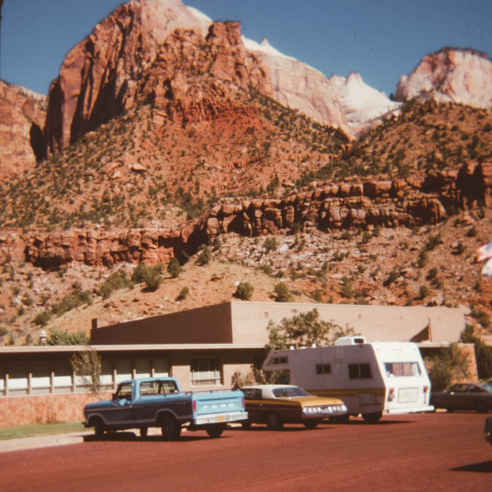 blue single cab pickup truck near rock mountain