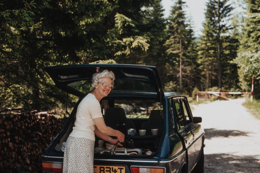 woman behind car