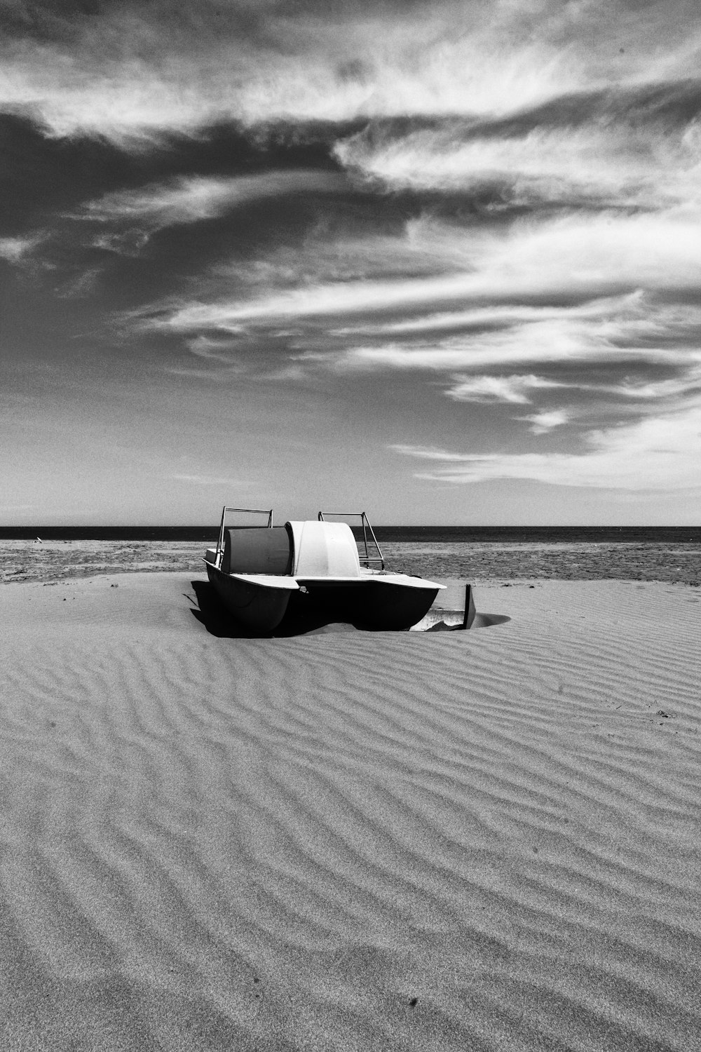 machine in a desert during daytime grey-scale photography