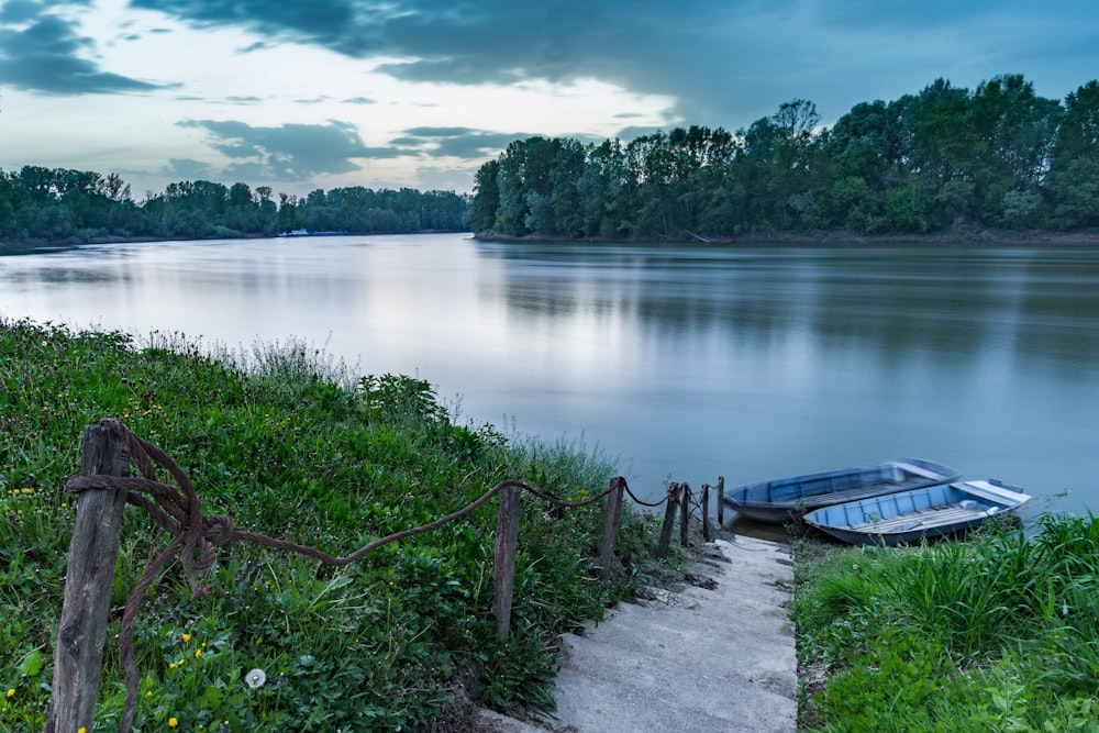 two blue boats on body of water