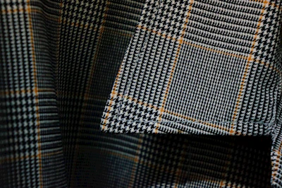 Close-up of a coonhound-themed t-shirt with intricate paw print designs on a rustic wooden table.