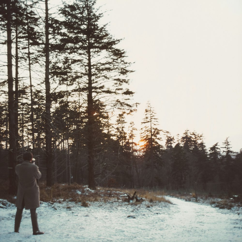 man standing near trees