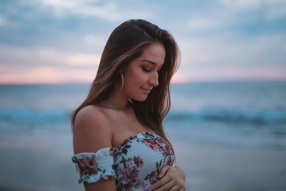 woman in white and pink off-shoulder floral top