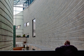 man looking at building