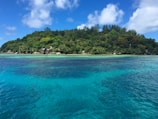 Panoramic shot of the lush island landscape surrounded by clear blue waters
