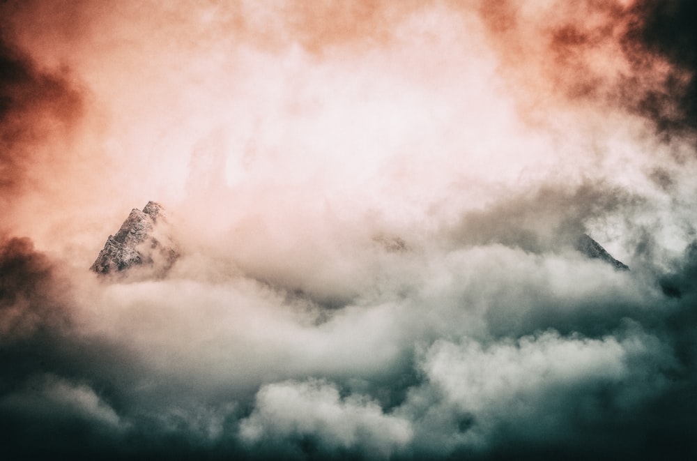 photography of mountain covered by clouds