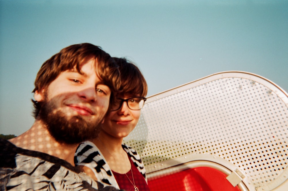 man and woman with surf board