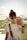 woman pouting her lips while holding smartphone in front of her face