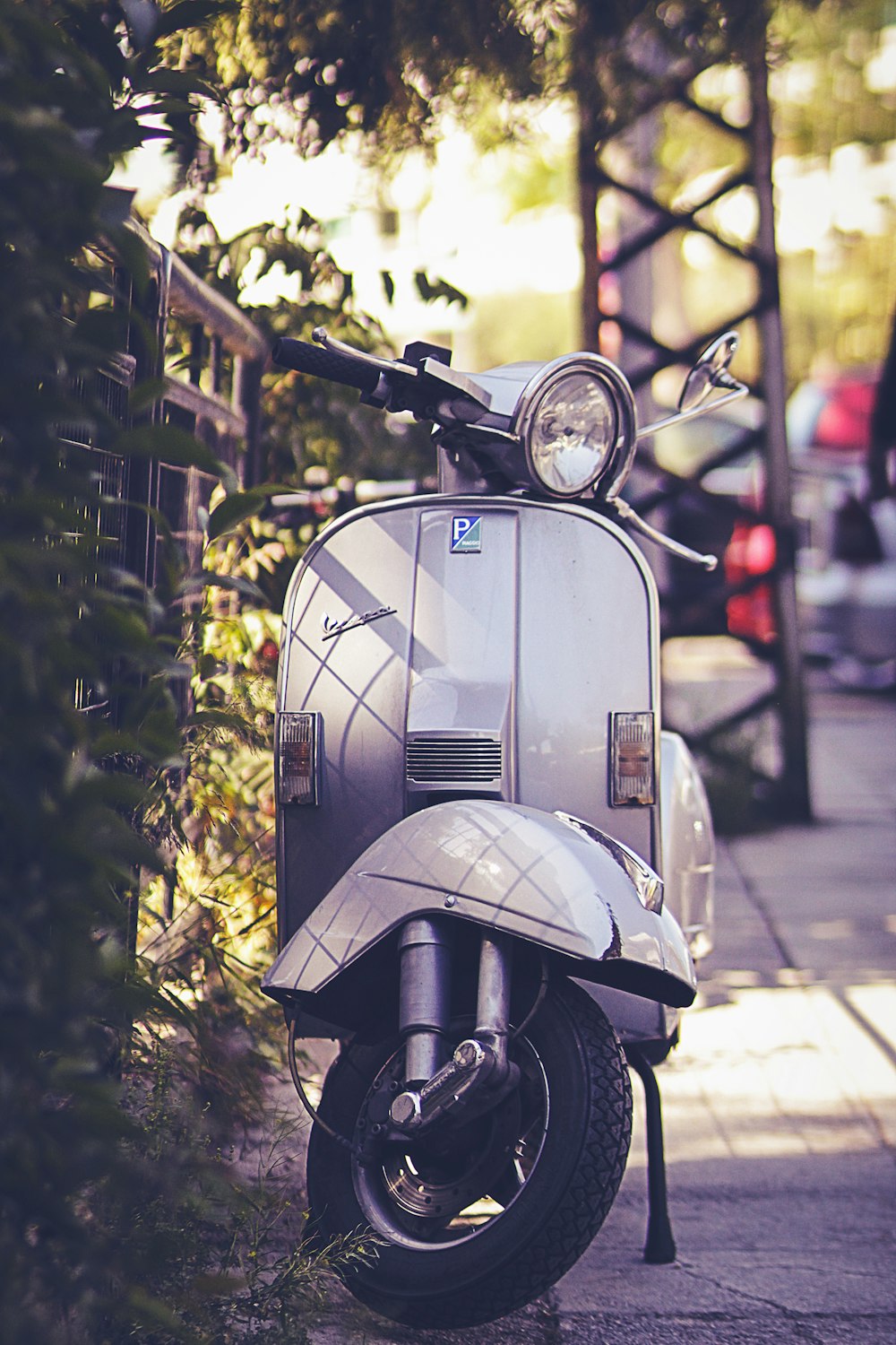 gray motor scooter on gray pathway