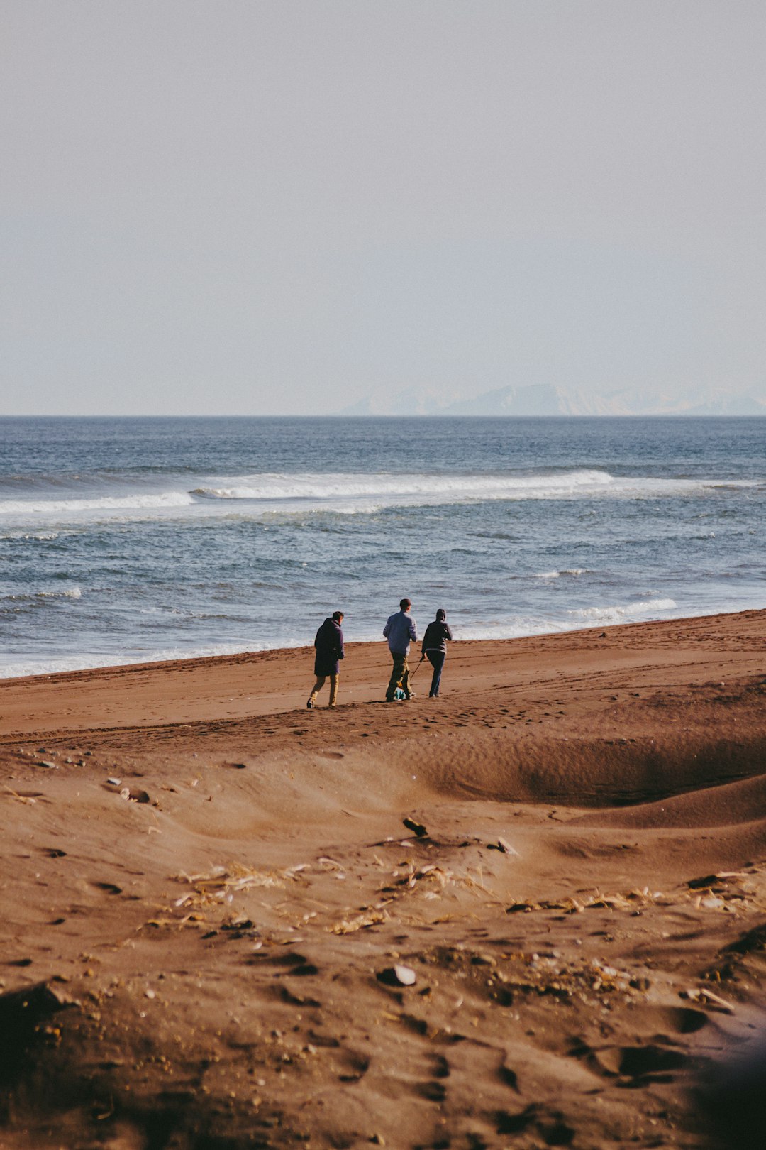 men walking on shore
