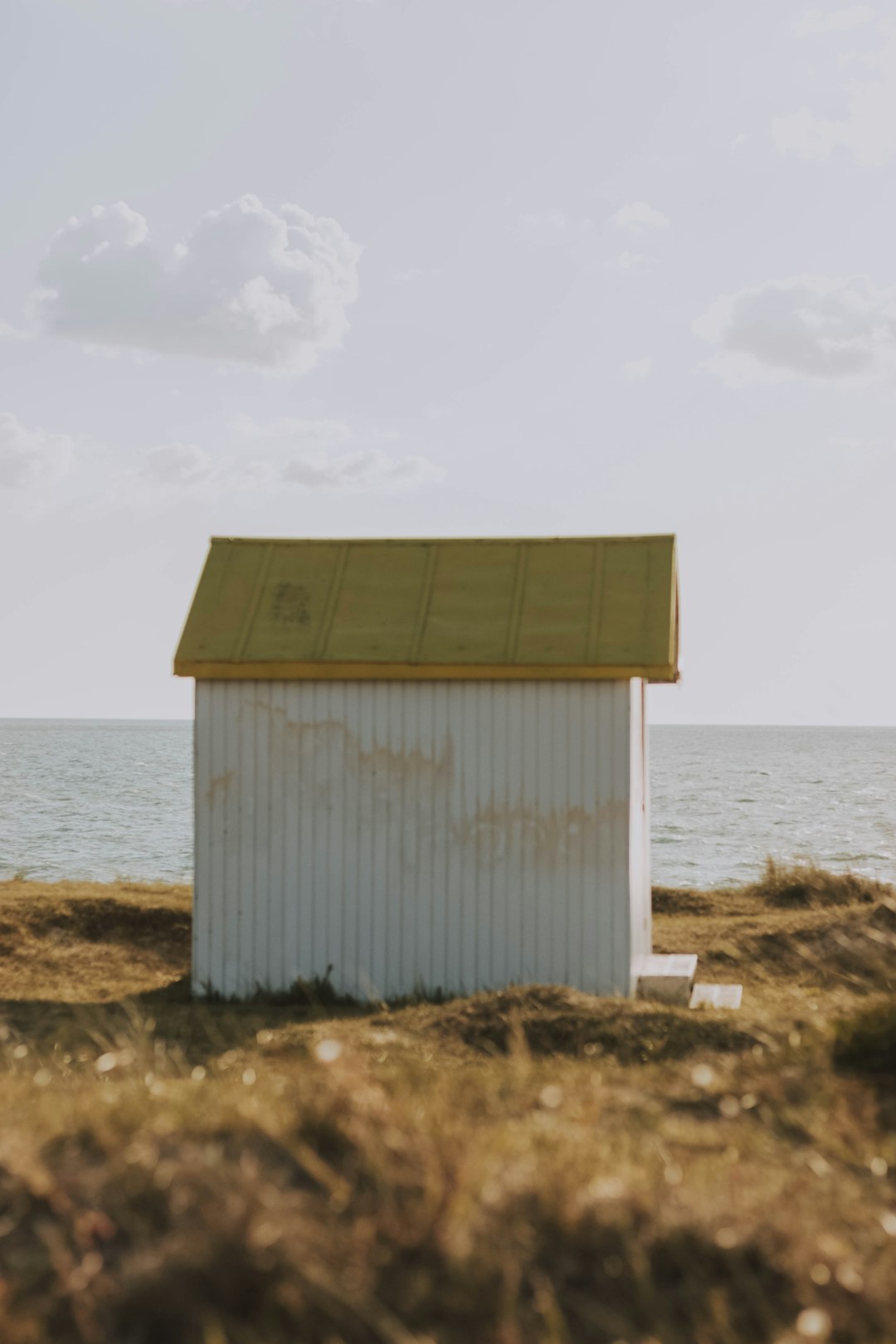white shed near shore during daytime