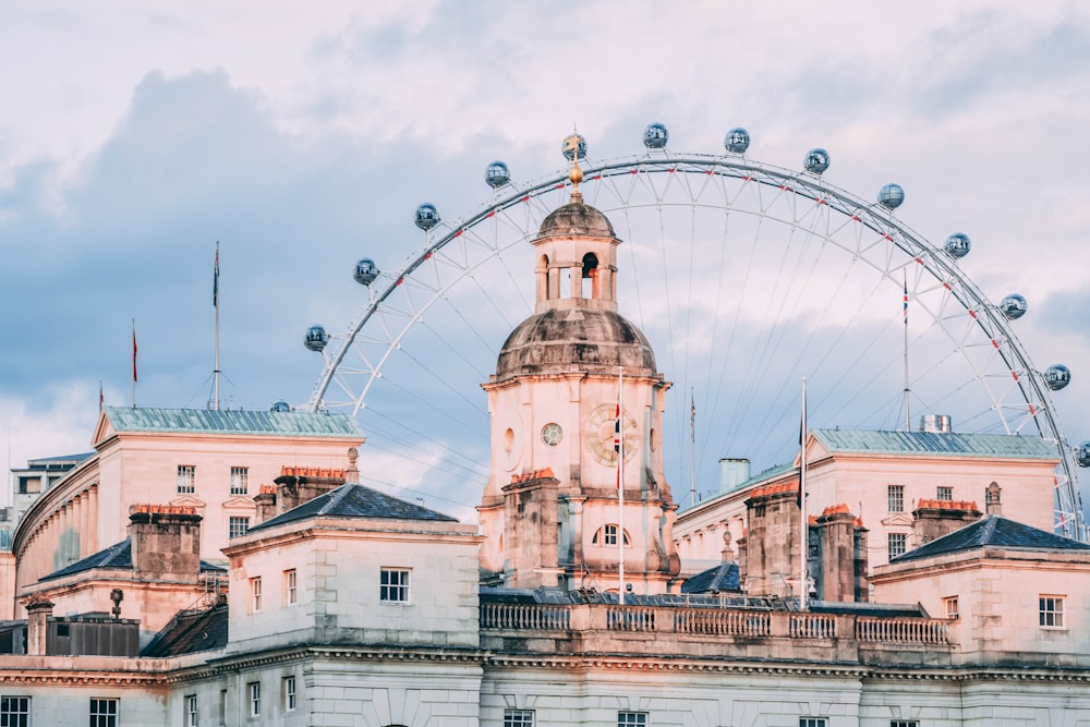 a large building with a ferris wheel in the background