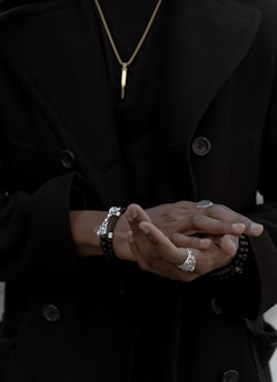 person wearing coat and jewelries