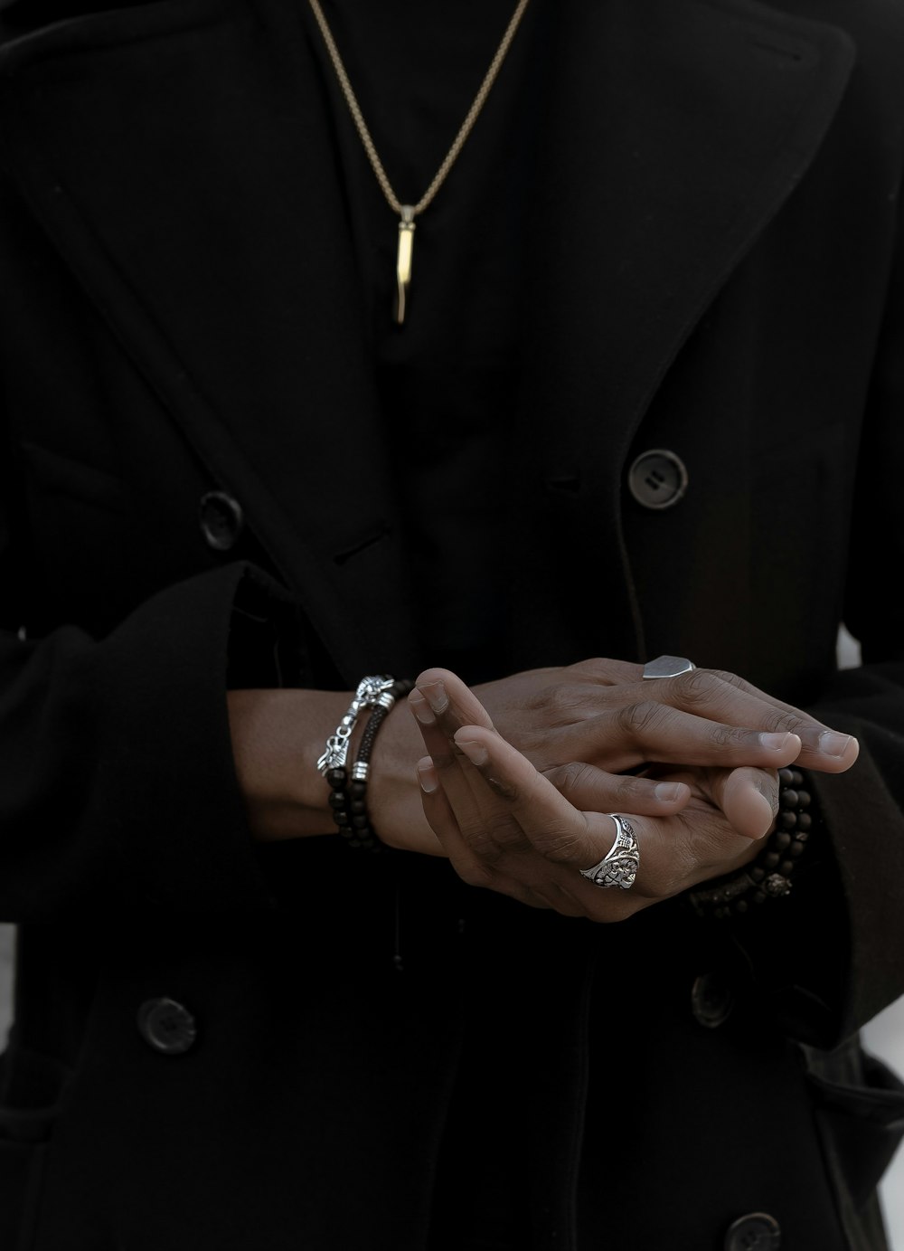 person wearing coat and jewelries