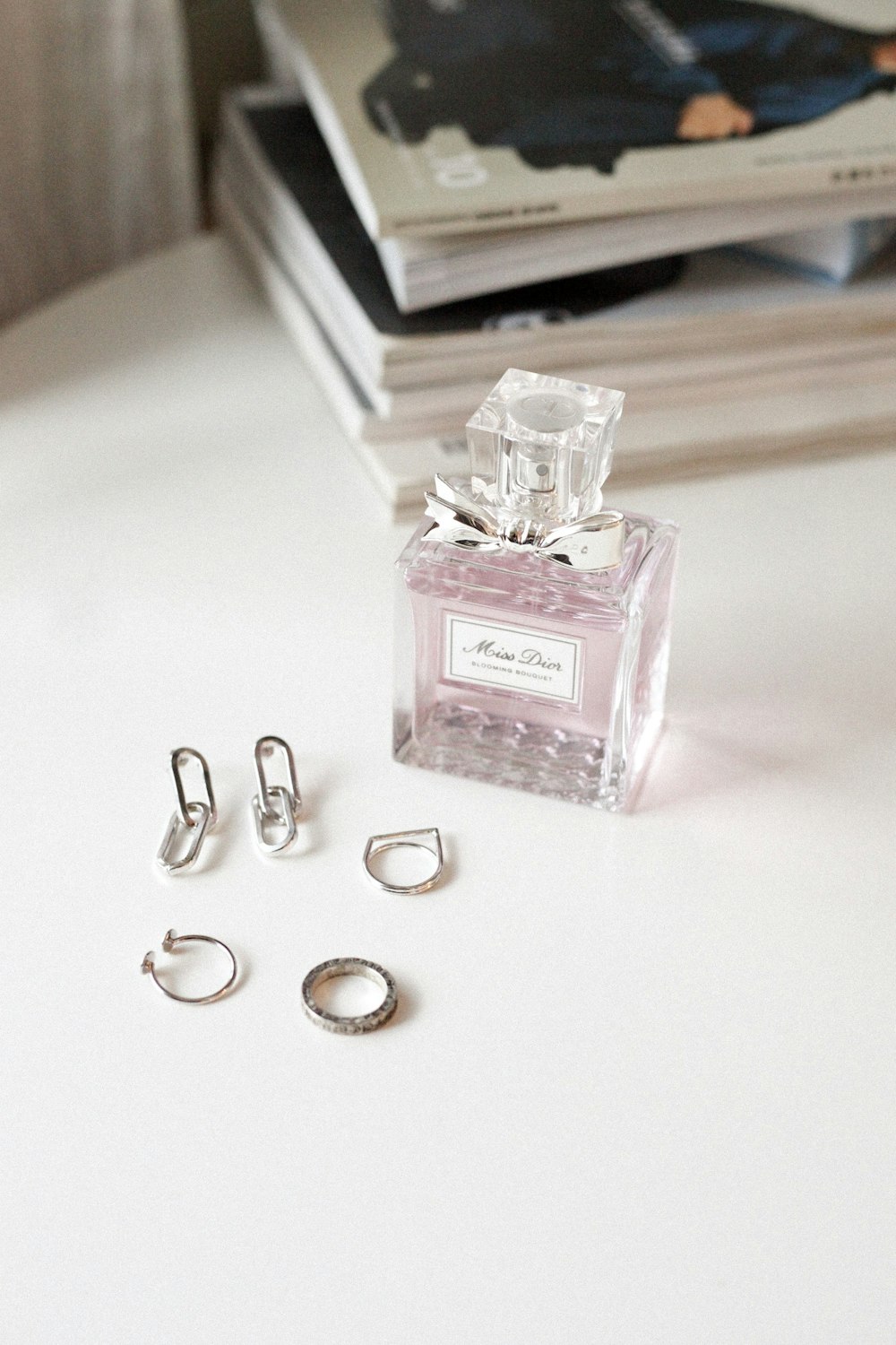 clear glass perfume bottle on white wooden table