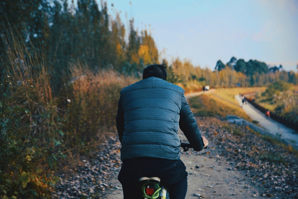 shallow focus photo of person riding bike during daytime