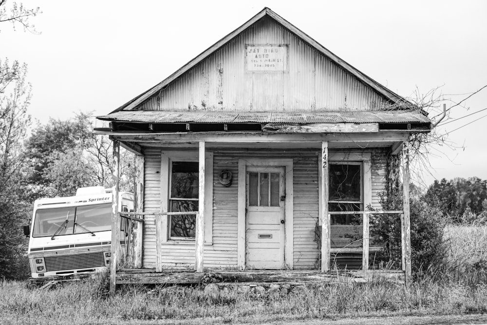 wooden house grayscale photo