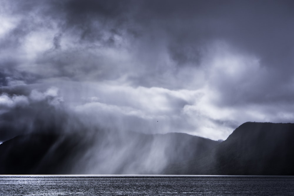 body of water under cloudy sky