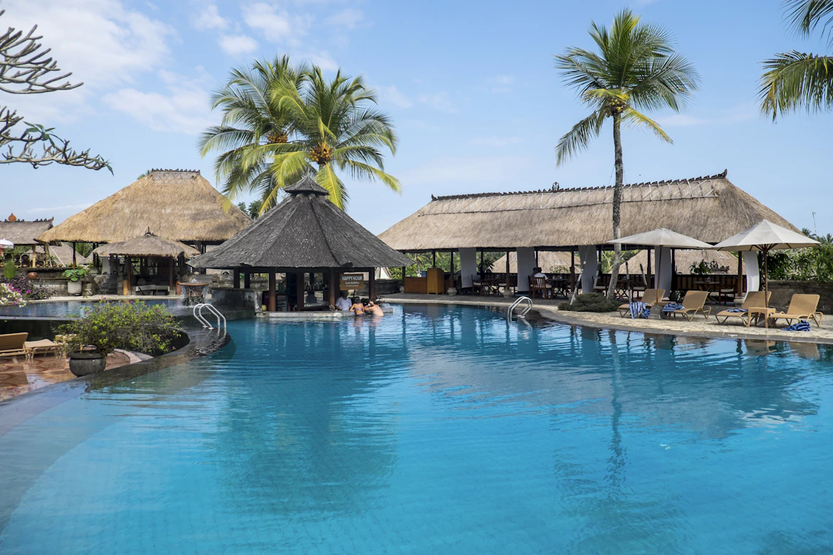 Luxury resort swimming pool overlooking emerald-green rice fields in the Hoi An countryside