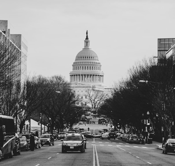 cars and bus parked at roadside near Capitol Hill