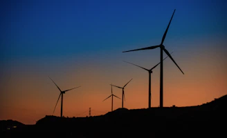Wind turbines in motion under a twilight sky with electric green data overlays showing efficiency boosts.