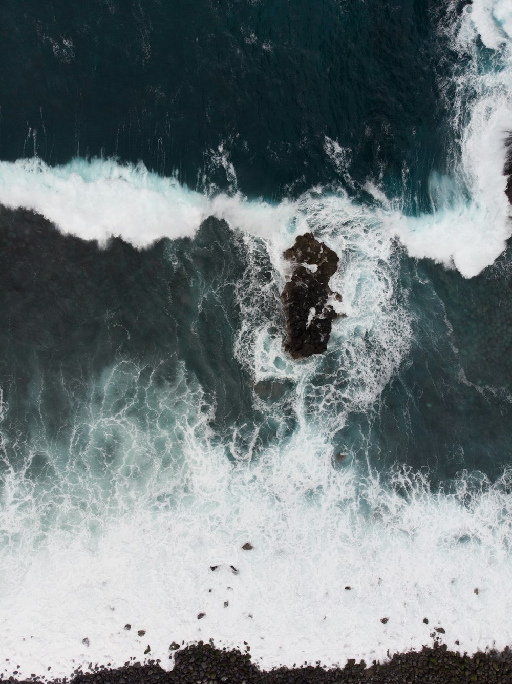 rock formation near body of water top-view photography