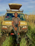man standing beside yellow vehicle