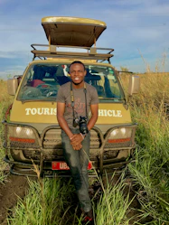 man standing beside yellow vehicle