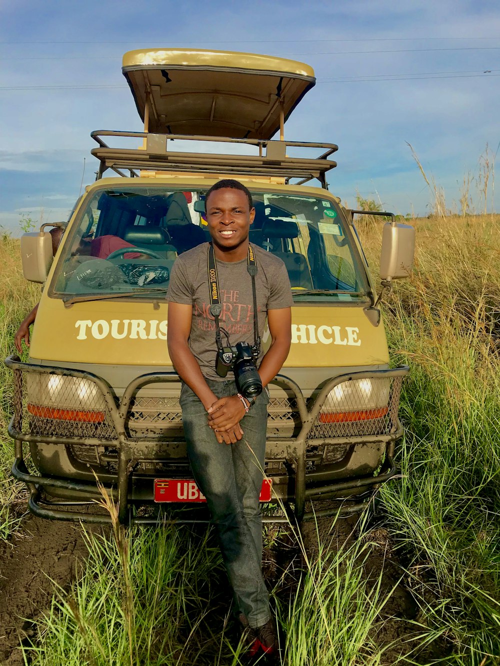 man standing beside yellow vehicle