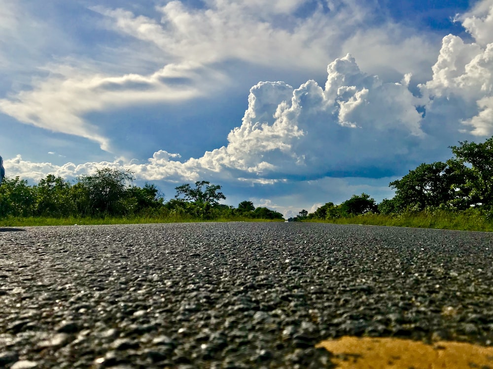 gray road under white clouds