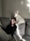 white dog beside woman sitting on couch