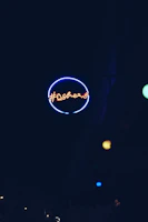 Close-up of a glowing acrylic sign with blue neon lighting in a modern office setting.