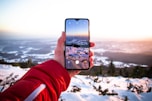person using smartphone camera viewing glacier field