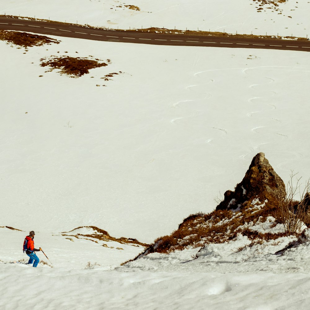 man walking on ice covered field during daytime